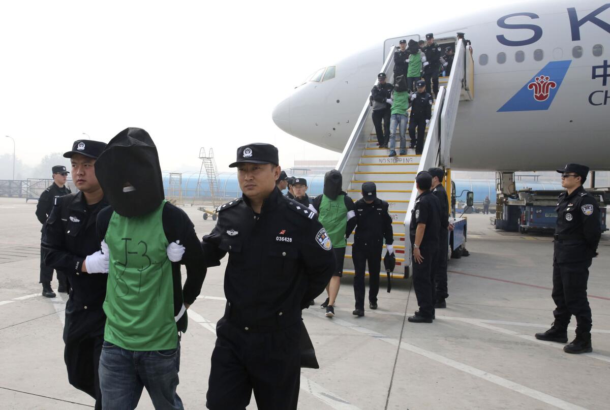 Chinese and Taiwanese citizens who were deported from Kenya arrive at Beijing Capital International Airport on April 13, 2016. The move focuses new attention on Beijing's willingness to assert its sovereignty claim over the Taiwan, and the leverage it wields over smaller nations in backing that position.