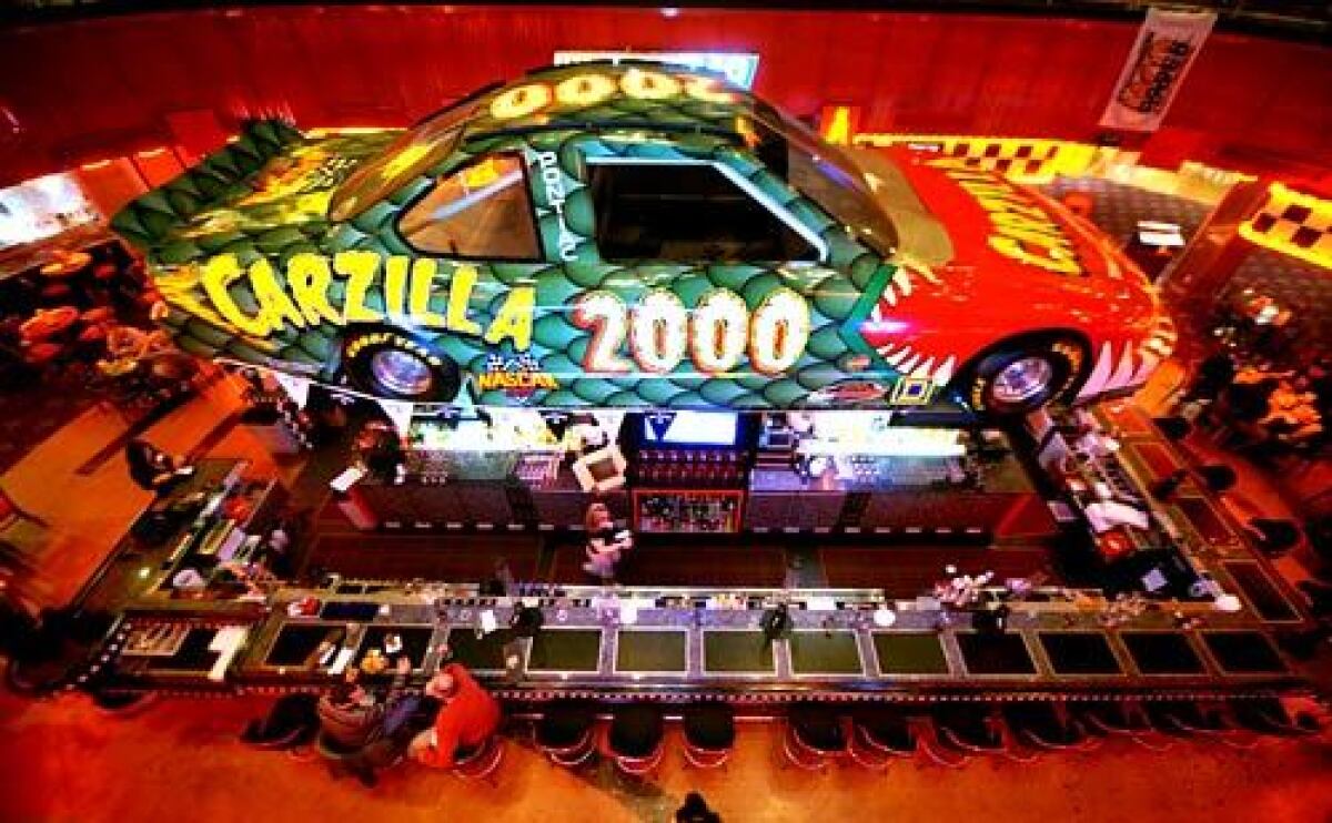 A giant race car sits above the bar area at the NASCAR Cafe Las Vegas Entertainment Center inside the Sahara Hotel & Casino.