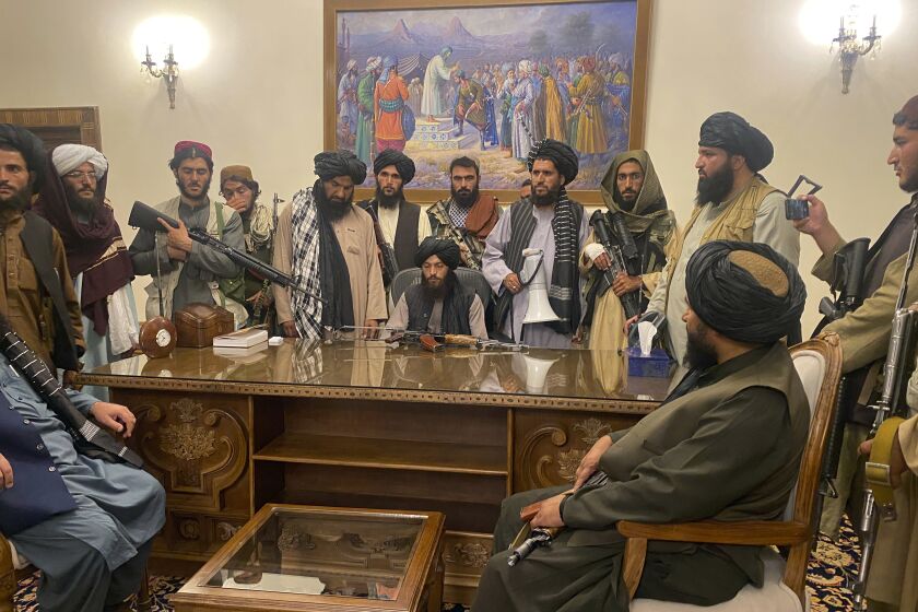 Taliban fighters take control of the Afghan presidential palace after President Ashraf Ghani fled the country, in Kabul, Afghanistan, Sunday, Aug. 15, 2021. (AP Photo/Zabi Karimi)