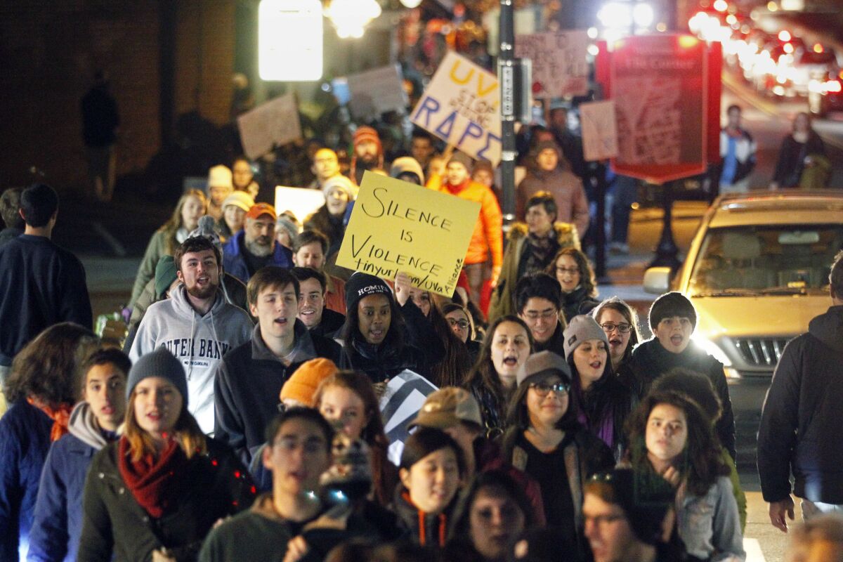 Demonstrators march along University Avenue on The Corner, a popular nighttime destination with bars and restaurants adjacent to the University of Virginia in response to the university's reaction to an alleged sexual assault of a student revealed in a recent Rolling Stone article.