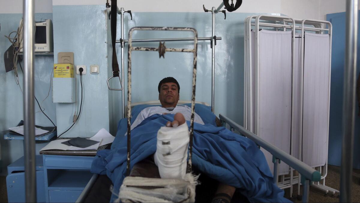 An injured man is treated at a hospital after a suicide bomber and gunmen attacked a public welfare building in Kabul, Afghanistan, on Monday.