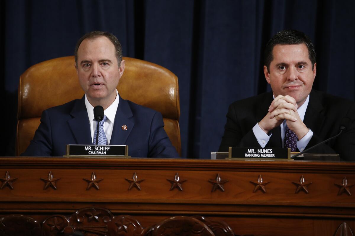 Chairman Adam Schiff speaks as ranking Republican Devin Nunes listens during the House Intelligence Committee impeachment hearing on Nov. 21. 