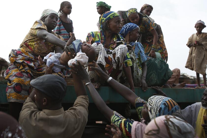 Muslims fleeing the violence in the Central African Republic climb into trucks bound for neighboring Cameroon. A convoy originating in the capital, Bangui, took two days to complete the journey west, occasionally contending with threats from militia members targeting Muslims.