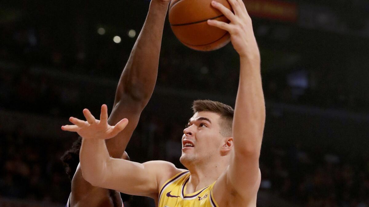 Lakers center Ivica Zubac goes to the basket against Philadelphia 76ers forward Joel Embid in the first quarter on Tuesday at Staples Center.