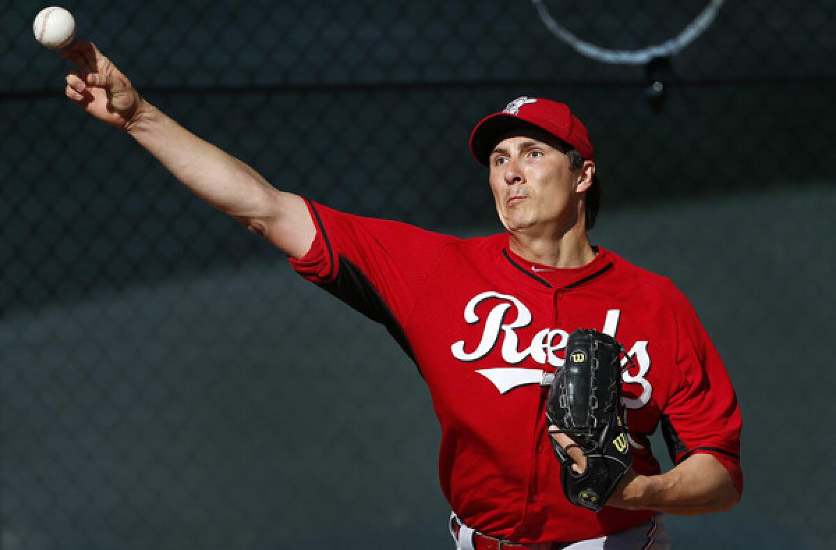 Cincinnati Reds pitcher Homer Bailey warms up for a workout on Saturday in Goodyear, Ariz.