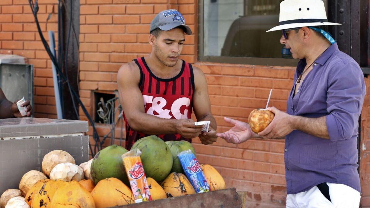 A man sells cocos to tourists in Havana on July 14, 2018.