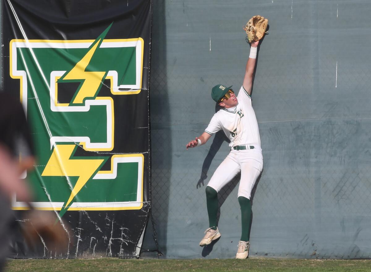 Edison right fielder Cody Kruis runs out room and into the fence trying to catch a hard-hit ball during Tuesday's game.