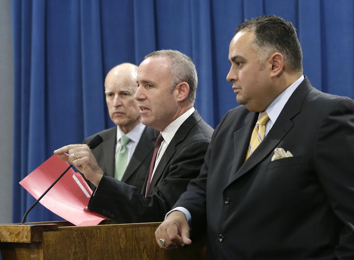 Gov. Jerry Brown and lawmakers are on track to approve a budget that spends less money than the state's Legislative Analyst expects the state to collect. Above: State Senate President Pro Tem Darrell Steinberg (D-Sacramento), center, discusses the budget compromise he and Assembly Speaker John Perez (D-Los Angeles), right, reached with Gov. Jerry Brown, during a news conference in Sacramento.