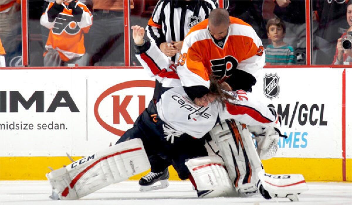 Philadelphia Flyers goalie Ray Emery and Washington Capitals goaltender Braden Holtby fight during the third period of a Nov. 1 game. Emery, who crossed the length of the ice to instigate the fight, was not suspended for his actions.