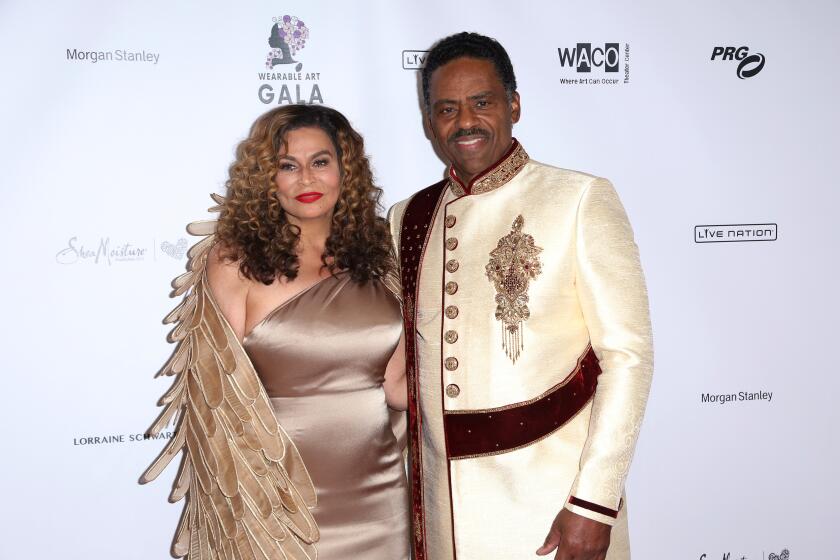 Tina Knowles Lawson, left, and Richard Lawson arrive at an art gala