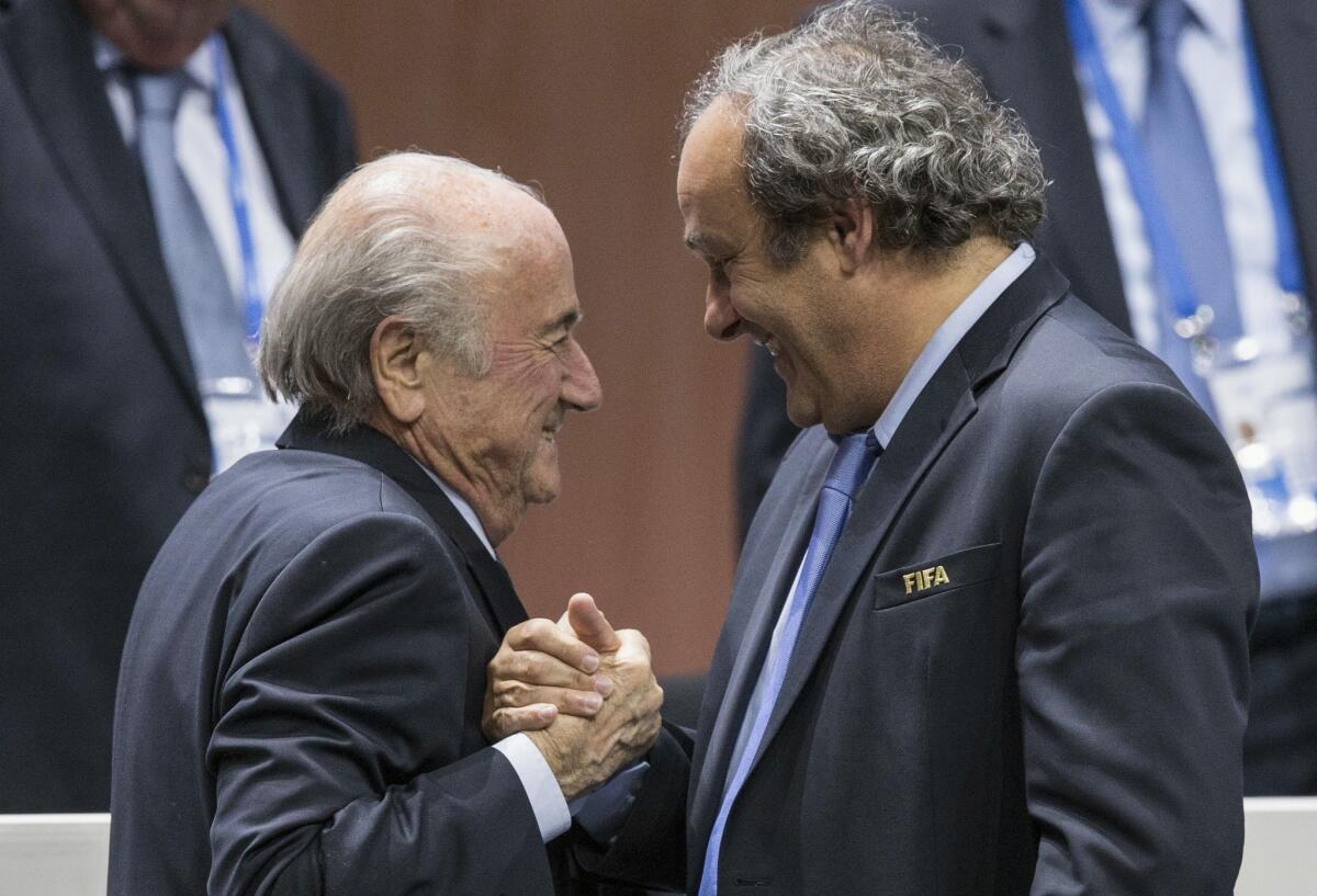 FIFA President Sepp Blatter, left, receives congratulations from UEFA President Michel Platini after Blatter's reelection on May 29.
