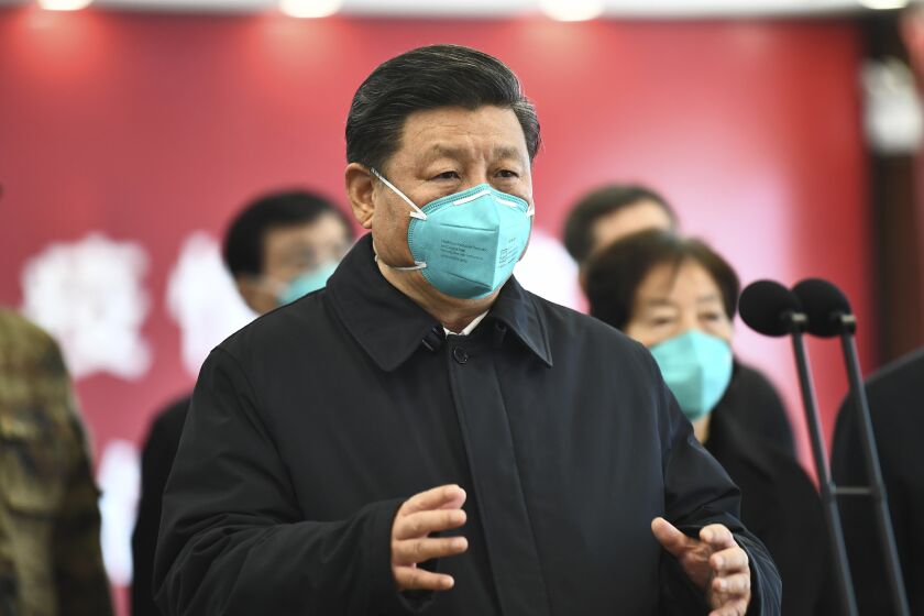 In this photo released by China's Xinhua News Agency, Chinese President Xi Jinping talks by video with patients and medical workers at the Huoshenshan Hospital in Wuhan in central China's Hubei Province, Tuesday, March 10, 2020. China's president visited the center of the global virus outbreak Tuesday as Italy began a sweeping nationwide travel ban and people worldwide braced for the possibility of recession. For most people, the new coronavirus causes only mild or moderate symptoms, such as fever and cough. For some, especially older adults and people with existing health problems, it can cause more severe illness, including pneumonia. (Xie Huanchi/Xinhua via AP)