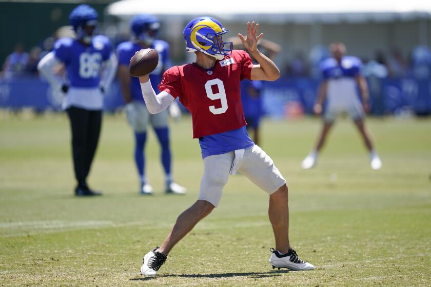 Rams quarterback Matthew Stafford (9) throws a pass during training camp 