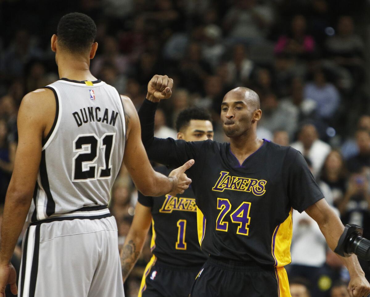 Los Angeles Lakers' Kobe Bryant (24) greets San Antonio Spurs' Tim Duncan before the game on Friday.