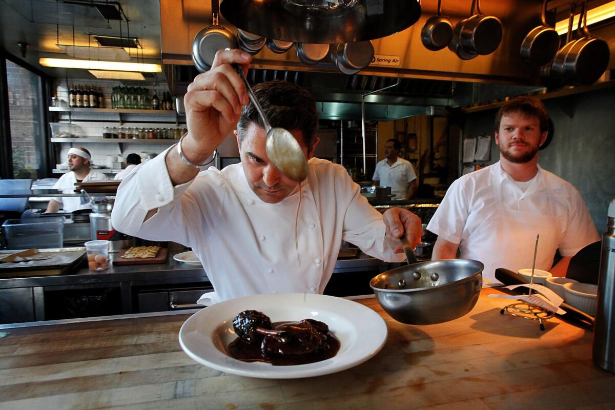 Church & State chef Tony Esnault puts the finishing touches on a plate of coq au vin. Esnault has transformed the downtown spot into a first-rate French bistro.