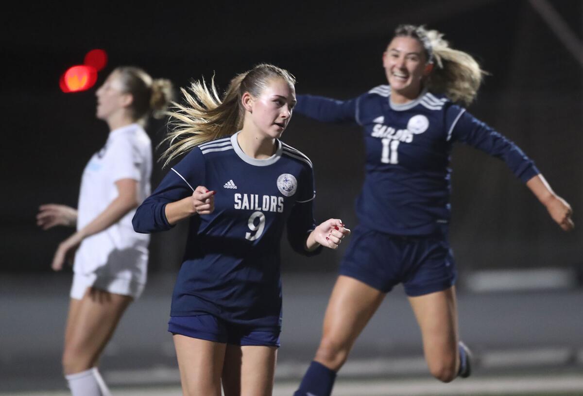 Newport Harbor's Sadie Koch (9) and teammate Emma Garrido (11), celebrate against rival Corona del Mar earlier this season.