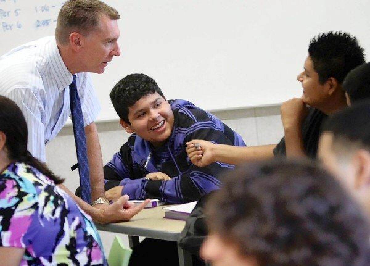 L.A. Unified Supt. John Deasy chats with Aldo Cid, center, and Alvaro Arran on the first day of school at the Hilda L. Solis Learning Academy in East Los Angeles. On Wednesday, Deasy expressed disappointment over a robo-call sent by the teachers union, urging members not to participate in the district’s voluntary performance review system.