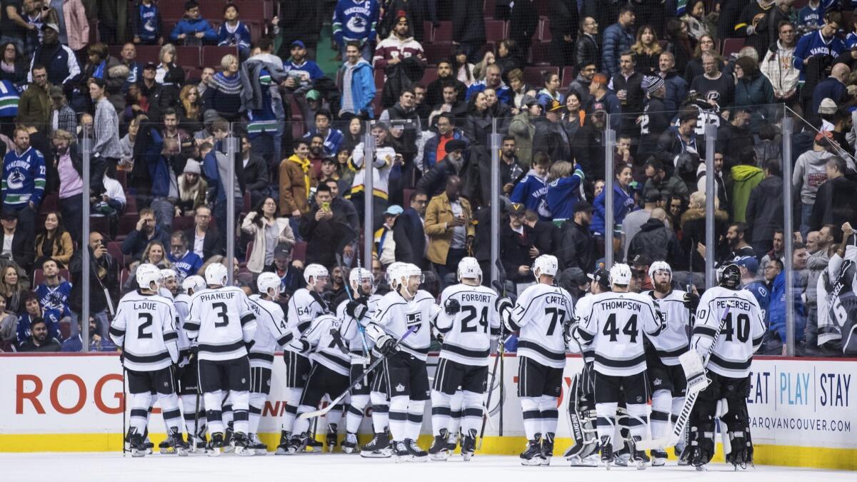 The Kings celebrate after defeating the Vancouver Canucks 2-1 during overtime on Tuesday.