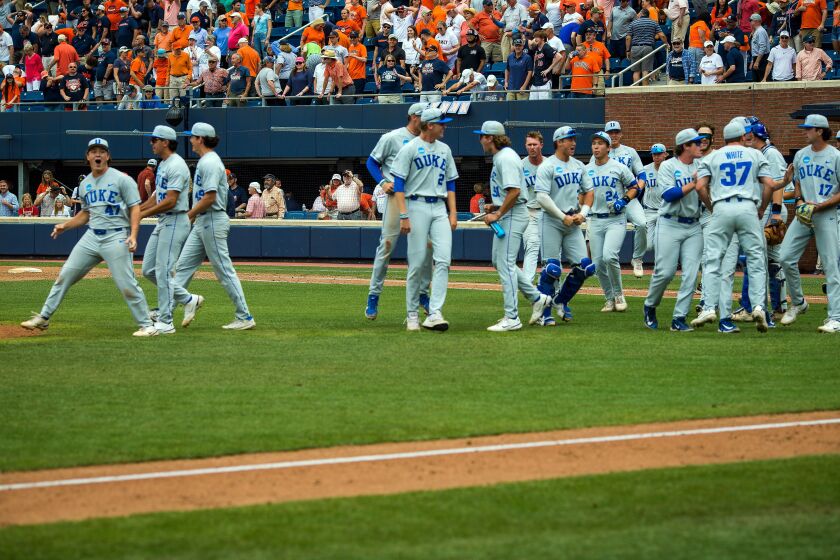 Duke players celebrate after defeating Virginia in an NCAA college baseball super regional game, Friday, June 9, 2023 in Charlottesville, Va. (AP Photo/John C. Clark)
