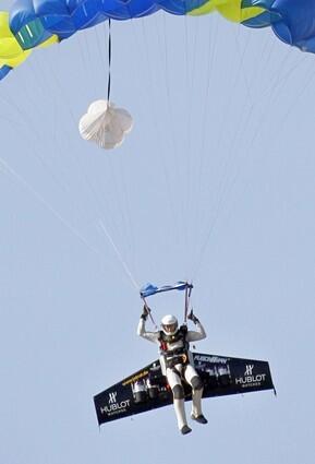 Yves Rossy parachutes toward his landing site near Dover, England.