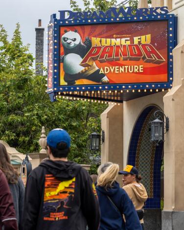 People line up under the marquee for the DreamWorks Theatre featuring Kung Fu Panda