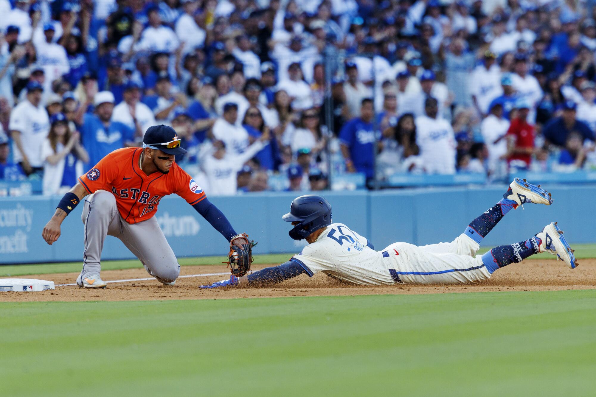 The Dodgers Mookie Betts Dodgers stop is labeled by the third base of Houston Astros Isaac Paredes.