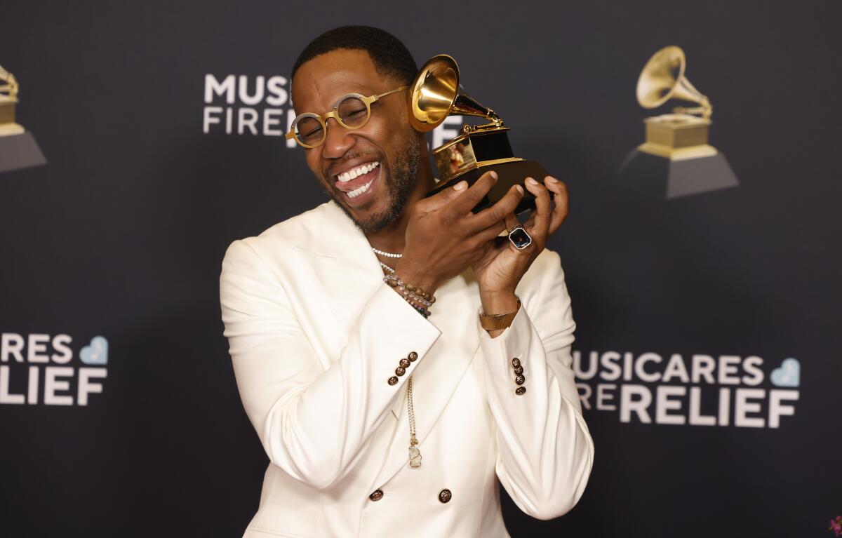 Cory Henry holds his Grammy Award.