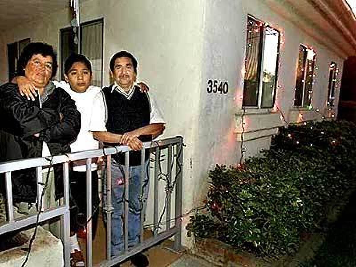 Yolanda and Rogelio Garcia with their son Angel, 15, at the three-bedroom home they were able to buy in Inglewood with help from a reader.