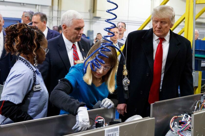 President-elect Donald Trump and Vice President-elect Mike Pence watch as employees work during a visit to Carrier factory, Thursday, Dec. 1, 2016, in Indianapolis, Ind. (AP Photo/Evan Vucci)