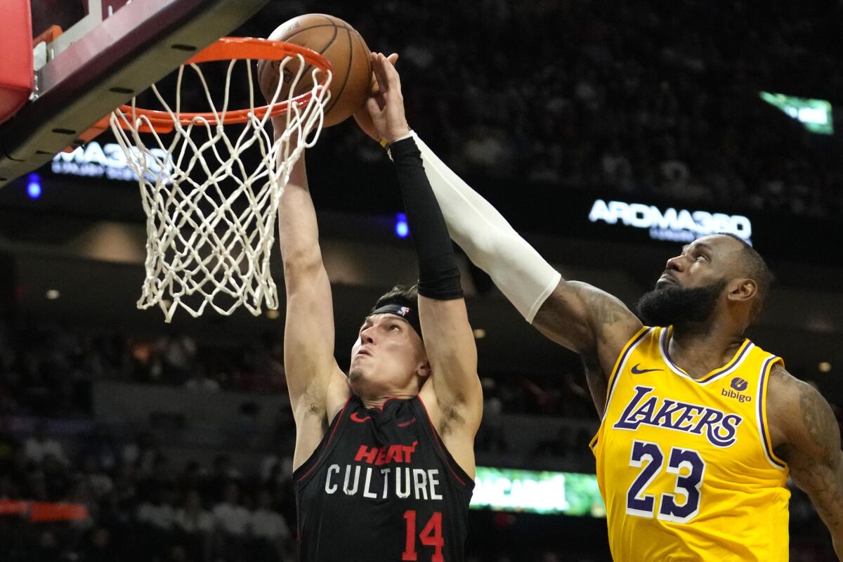 Lakers star LeBron James blocks a shot by Miami Heat guard Tyler Herro during Monday's game.