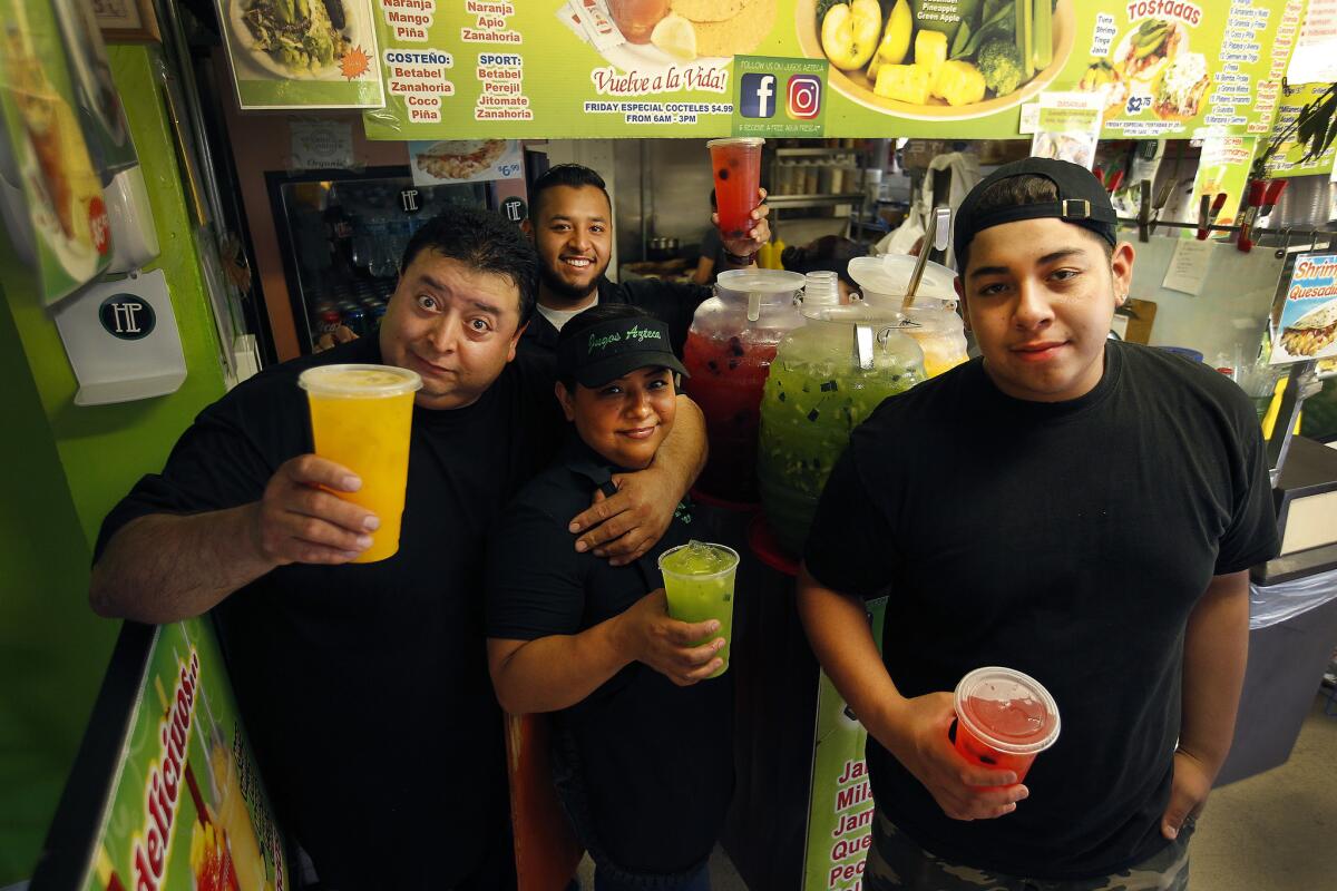 From left, Efrain Peña, son Raul Peña, wife Veronica Rodriguez and son Randy Peña, at their juice bar Jugos Azteca in Highland Park.