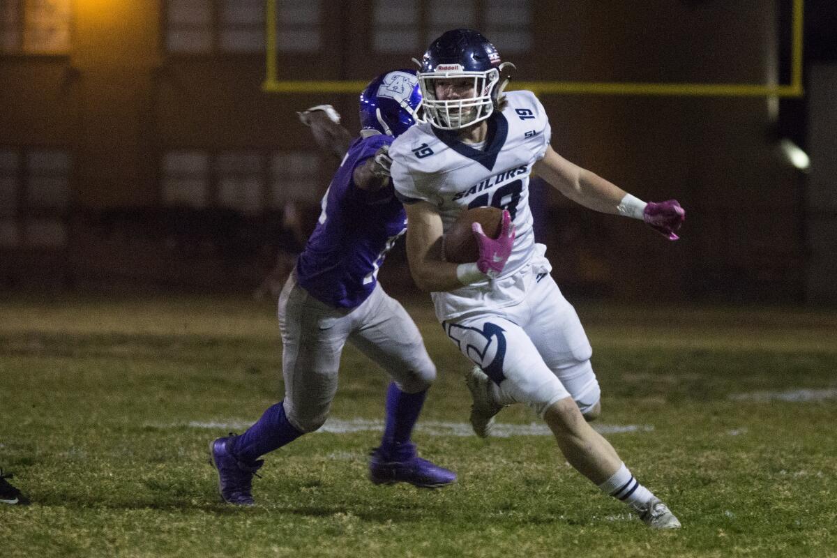 Newport Harbor's Aidan Goltz runs for a first down against St. Anthony in the first round of the CIF Southern Section Division 9 playoffs on Friday at Clark Field in Long Beach.