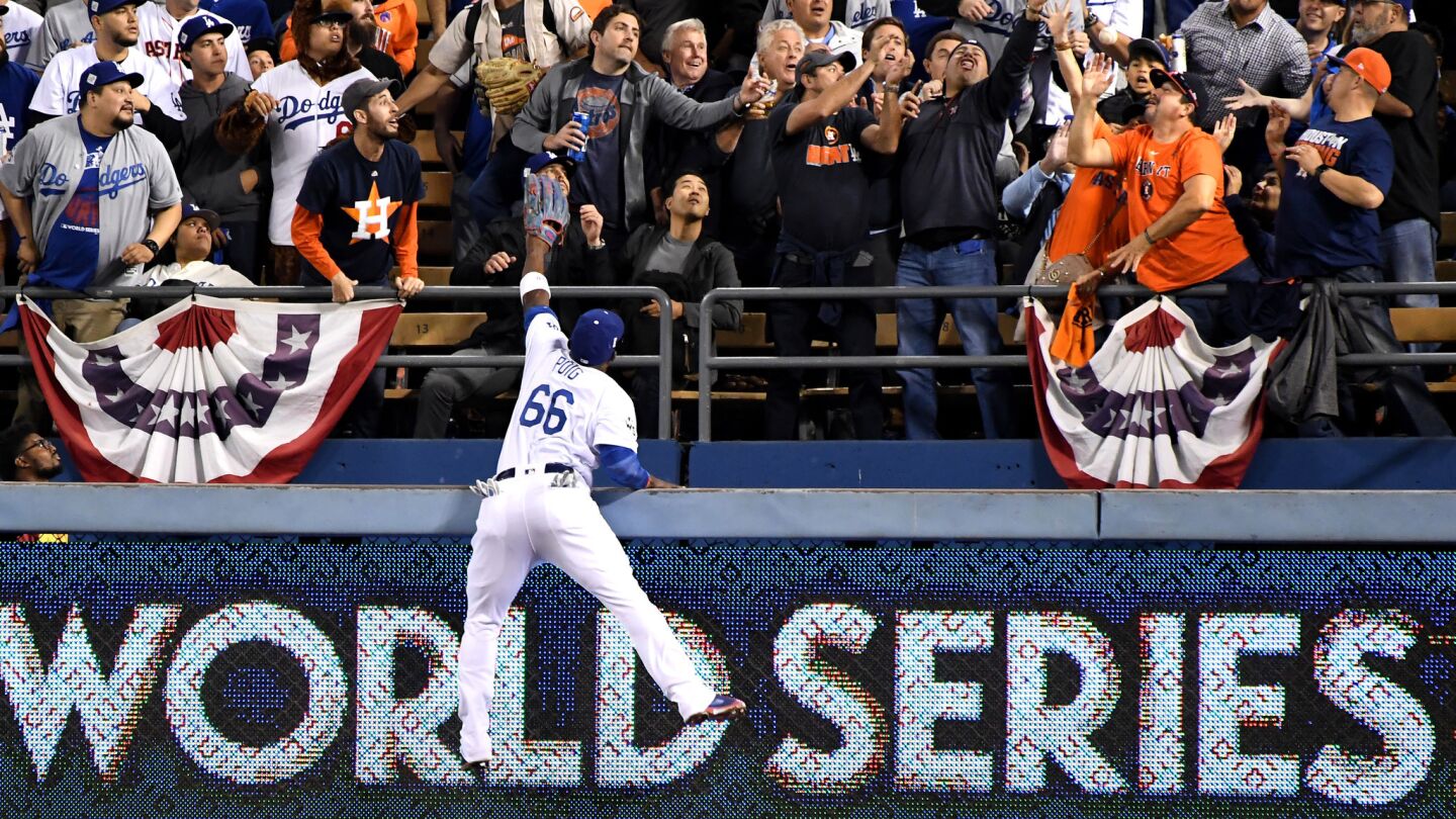 Dodgers right fielder Yasiel Puig climbs the wall but can't reach a home run ball hit by Astros George Springer in the 3rd inning.