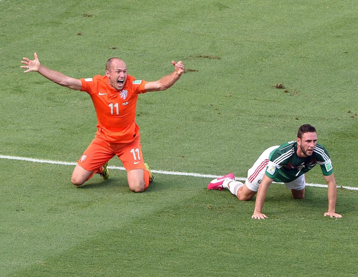 Arjen Robben, left, of the Netherlands reacts after a tackle during round of 16 match against Mexico.