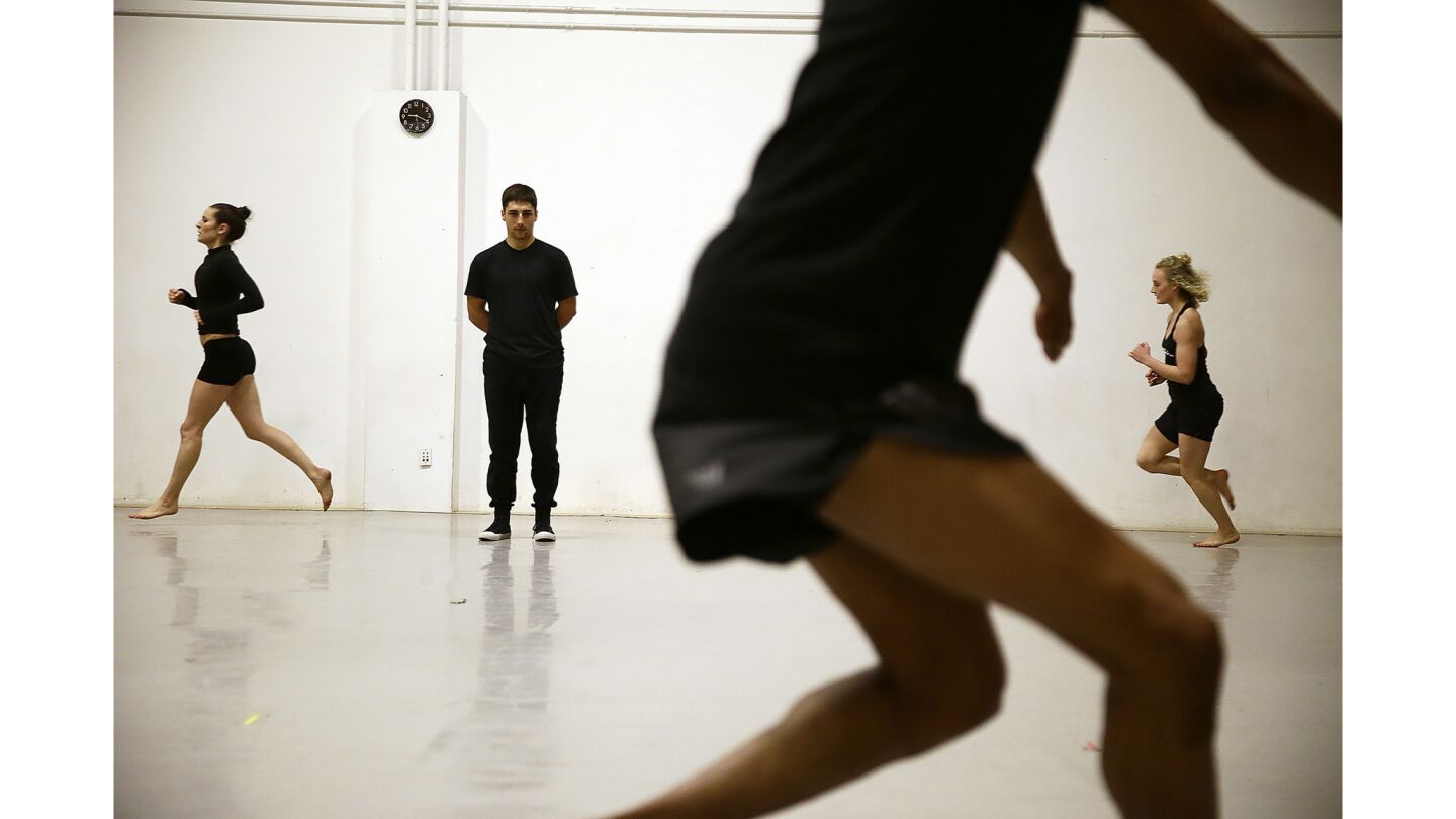 Jacob Jonas the Company rehearses for an upcoming show at the Wallis. Jonas looks on as dancers rehearse a physically grueling piece where they run and jump continuously for minutes.