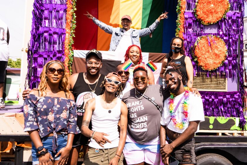 Members of the San Diego Black LGBTQ Coalition stand in front of their Pride float at San Diego Pride on July 16, 2022.