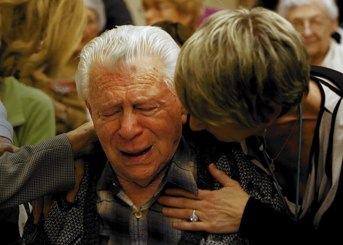 Holocaust survivor Ernest Braunstein is comforted by Betsey Windmuller Roberts after the play "The Trial of Franklin Delano Roosevelt" was performed at the Los Angeles Jewish Home in Reseda. "I don’t want anybody to forget what happened to us," said Braunstein, 89. The SS St. Louis Legacy Project produces the play that puts FDR on trial for turning away a cruise liner filled with Jewish refugees in 1939. Roberts' parents were both on the ill-fated voyage.