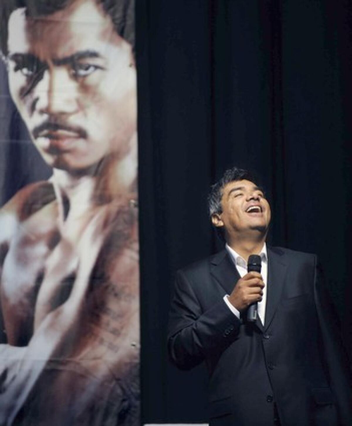 Comedian George Lopez works the room before Oscar De La Hoya and Manny Pacquiao take the stage Friday for their official weigh-in.