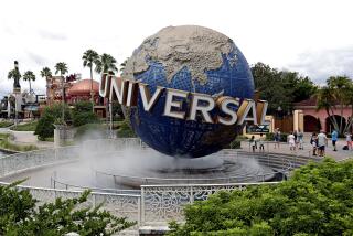 The giant, rotating Universal globe in a bed of fog surrounded by palm trees and other greenery