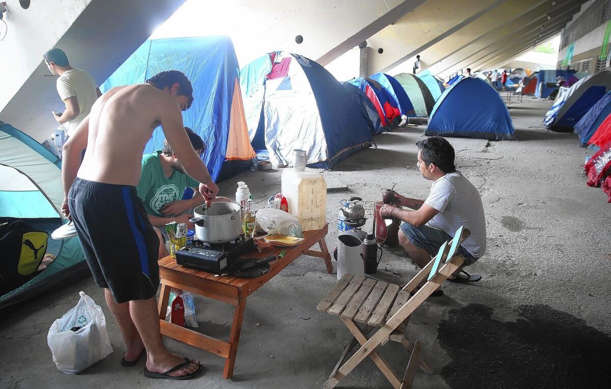 Fans of Argentina's soccer team use the Sambadrome parking lot in Rio de Janeiro as a makeshift campground before the World Cup final match against Germany.