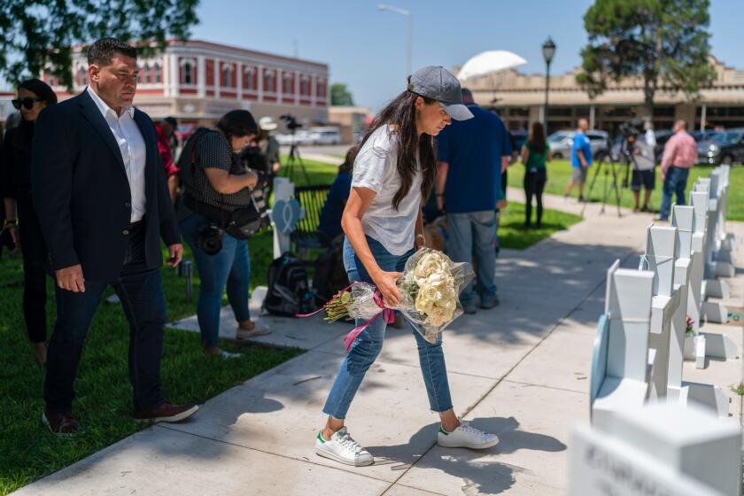 Meghan Markle, Duchess of Sussex, visits a memorial site with flowers, Thursday, May 26, 2022 in Uvalde, TX.