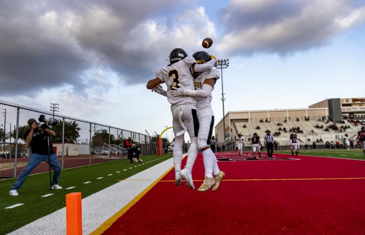 Robert Sarmiento and Roman Sanchez celebrate San Pedro touchdown.