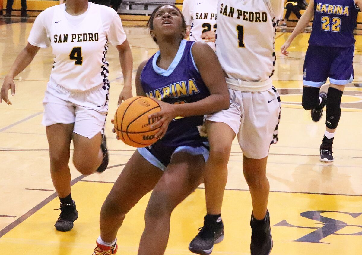Marina's Rylee Bradley (23) drives to the basket against San Pedro on Tuesday.