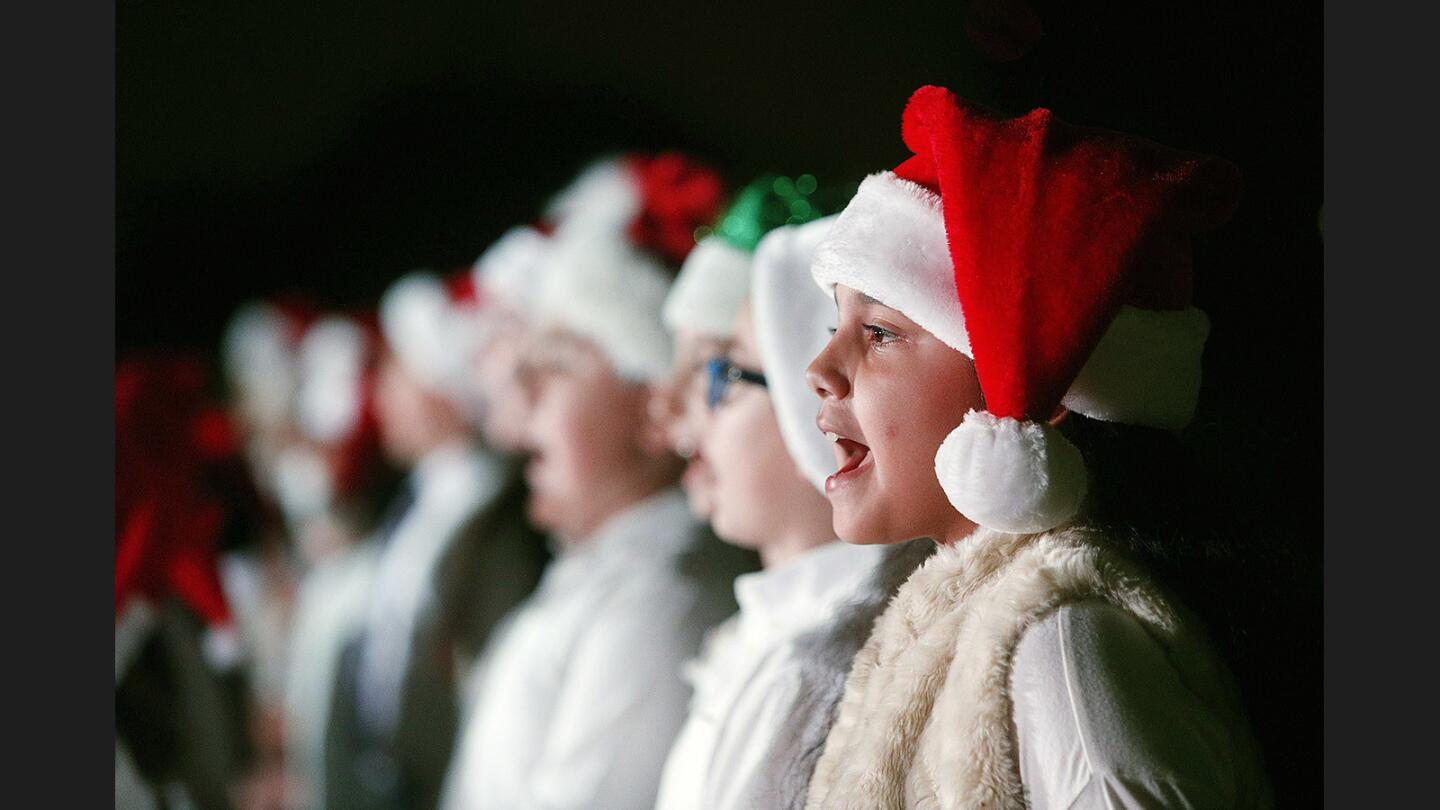 Balboa Elementary School sixth grader Natalie Zadoyan, 11, sings the finale at the annual holiday tree lighting in Perkins Plaza at Glendale City Hall on Thursday, November 30, 2017. The brief event highlights included the lighting of the tree, singing by Balboa Elementary School students, and Santa Claus.