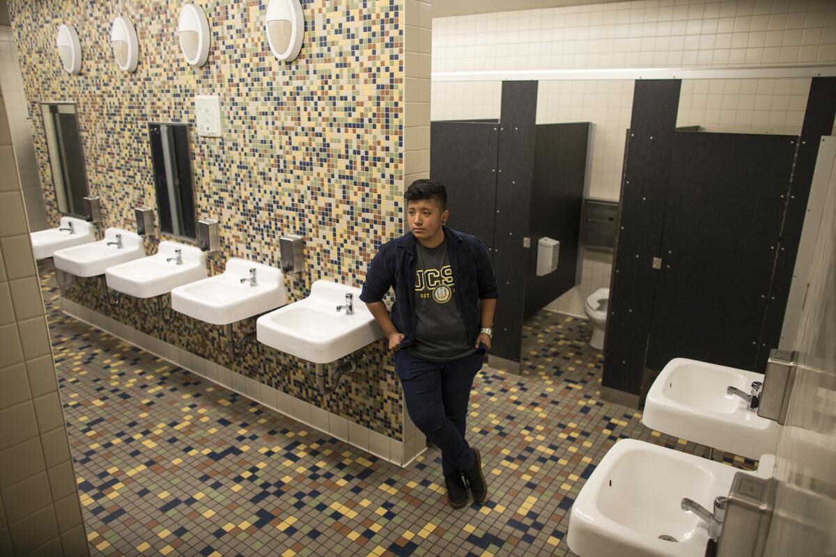 Transgender student Alonzo Hernandez, 17, stands in the first multistall gender-neutral bathroom at the Santee Education Complex, and in the Los Angeles Unified School District.