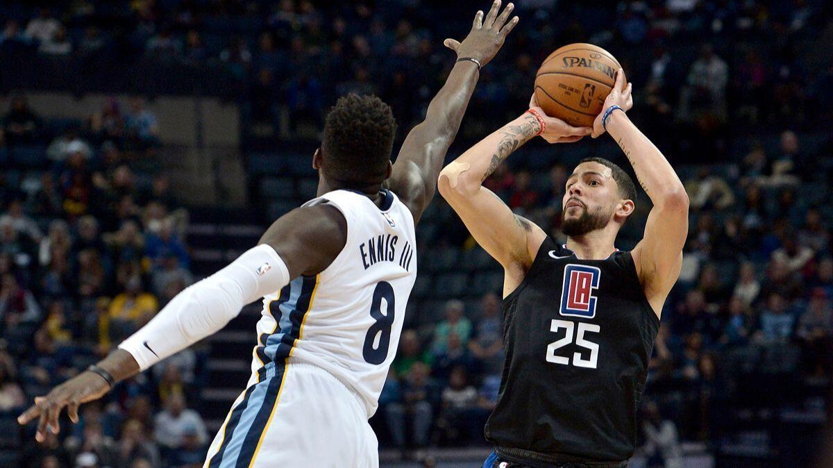 Clippers guard Austin Rivers (25) shoots against Memphis Grizzlies forward James Ennis III in the first half on, Dec. 23, 2017.