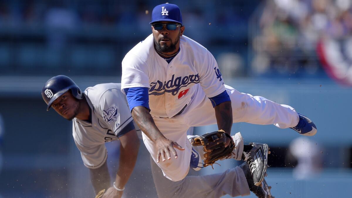 San Diego Padres' Justin Upton, left, is forced out at second by D second baseman Howie Kendrick throws out Will Middlebrooks at first during the eighth inning of an opening day baseball game, Monday, April 6, 2015, in Los Angeles. (AP Photo/Mark J. Terrill)