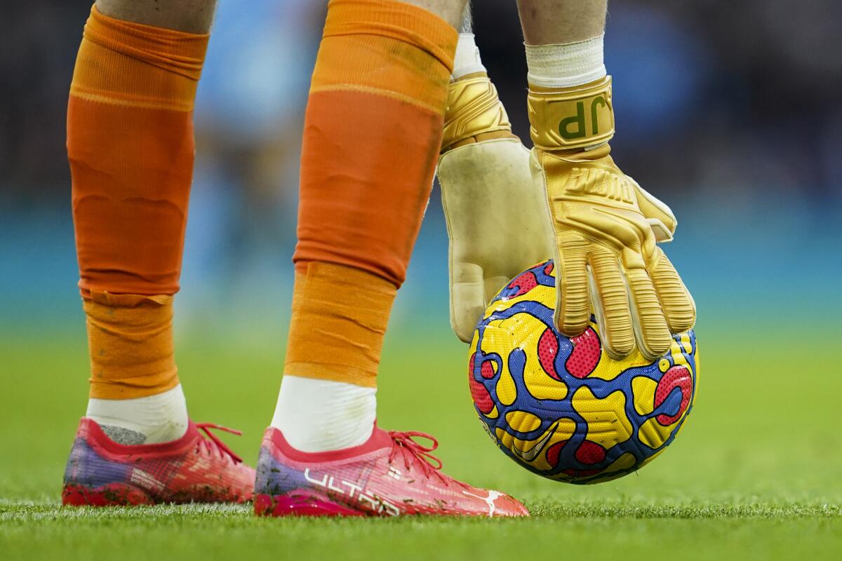 Everton's goalkeeper Jordan Pickford places the ball during the English Premier League soccer match between Manchester City and Everton at Etihad stadium in Manchester, England, Sunday, Nov. 21, 2021. (AP Photo/Jon Super)