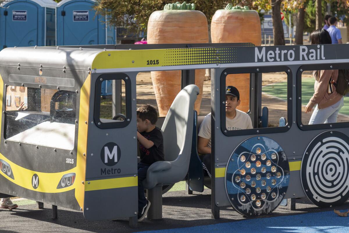 Kids playing on a playground version of a Metro Rail car
