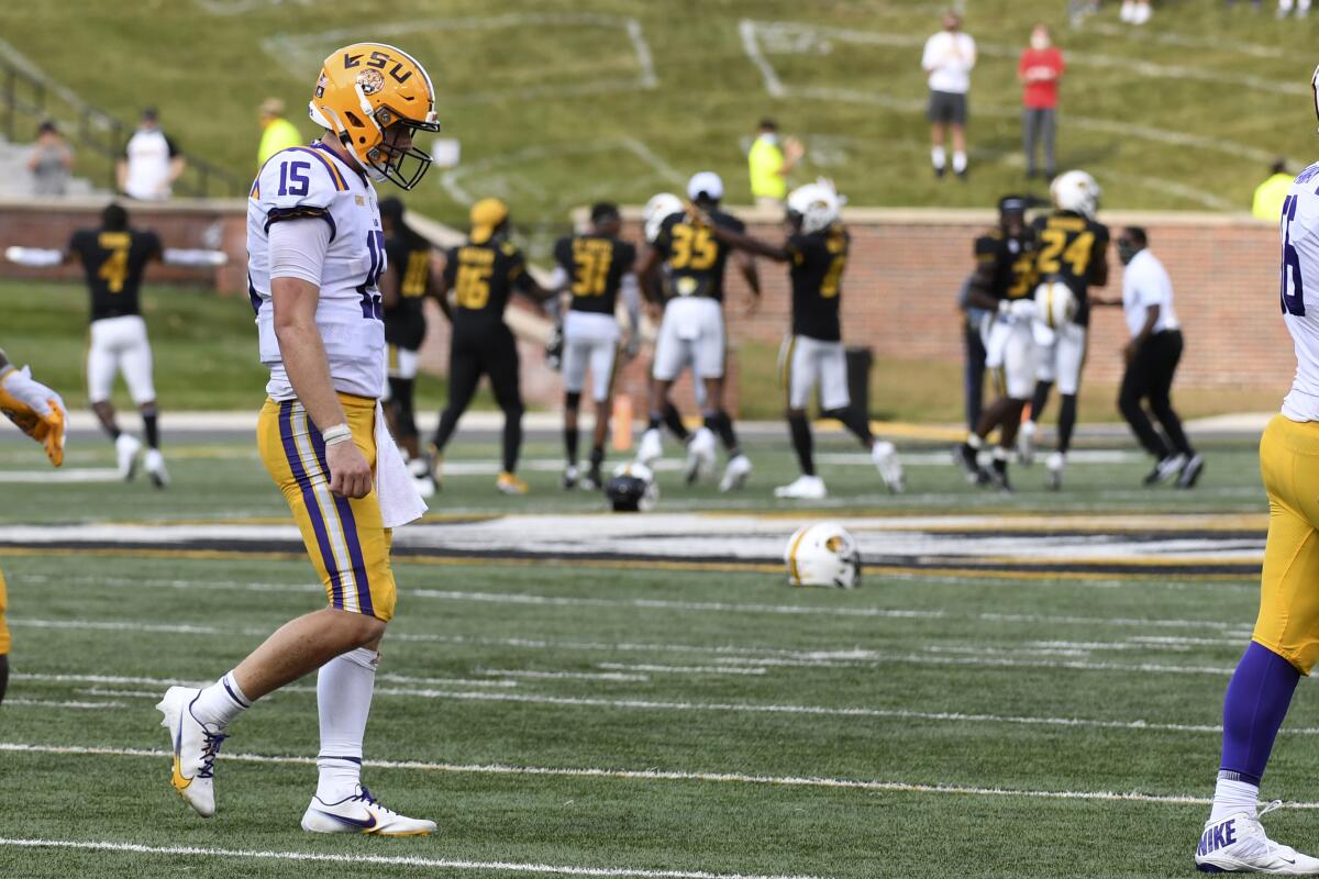 LSU quarterback Myles Brennan heads off the field as Missouri players celebrate their upset win Oct. 10, 2020.